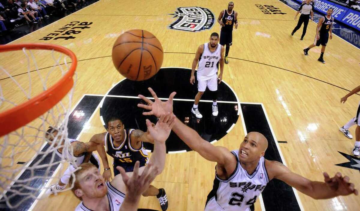 Spurs' Matt Bonner and Spurs' Richard Jefferson grab for a rebound against Jazz's Derrick Favors during second half action Saturday April 9, 2011 at the AT&T Center. The Spurs won 111-102. (PHOTO BY EDWARD A. ORNELAS/eaornelas@express-news.net)