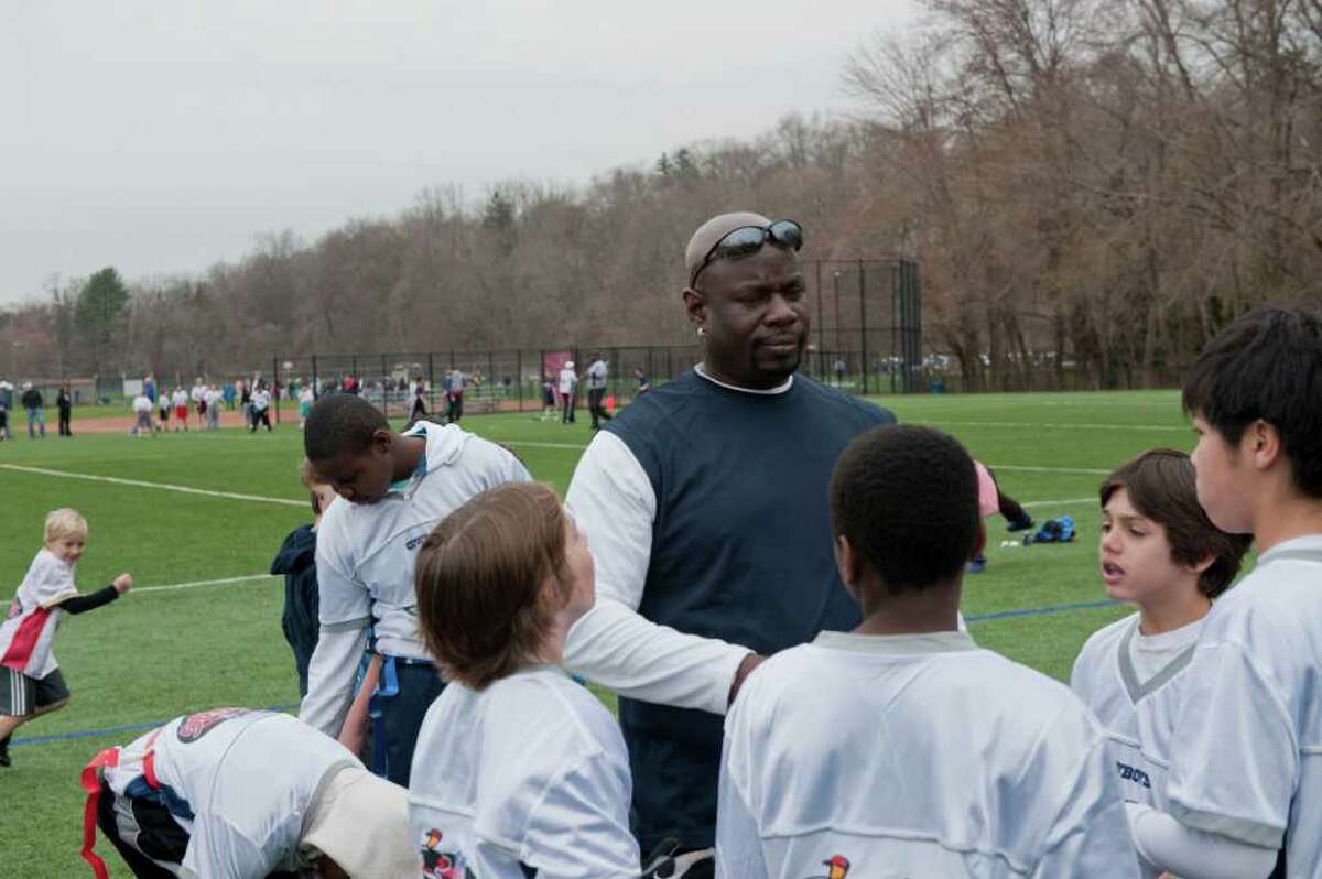 Greenwich Police Officer Dee Fludd coaches flag football Sunday April 10 at Greenwich High School .