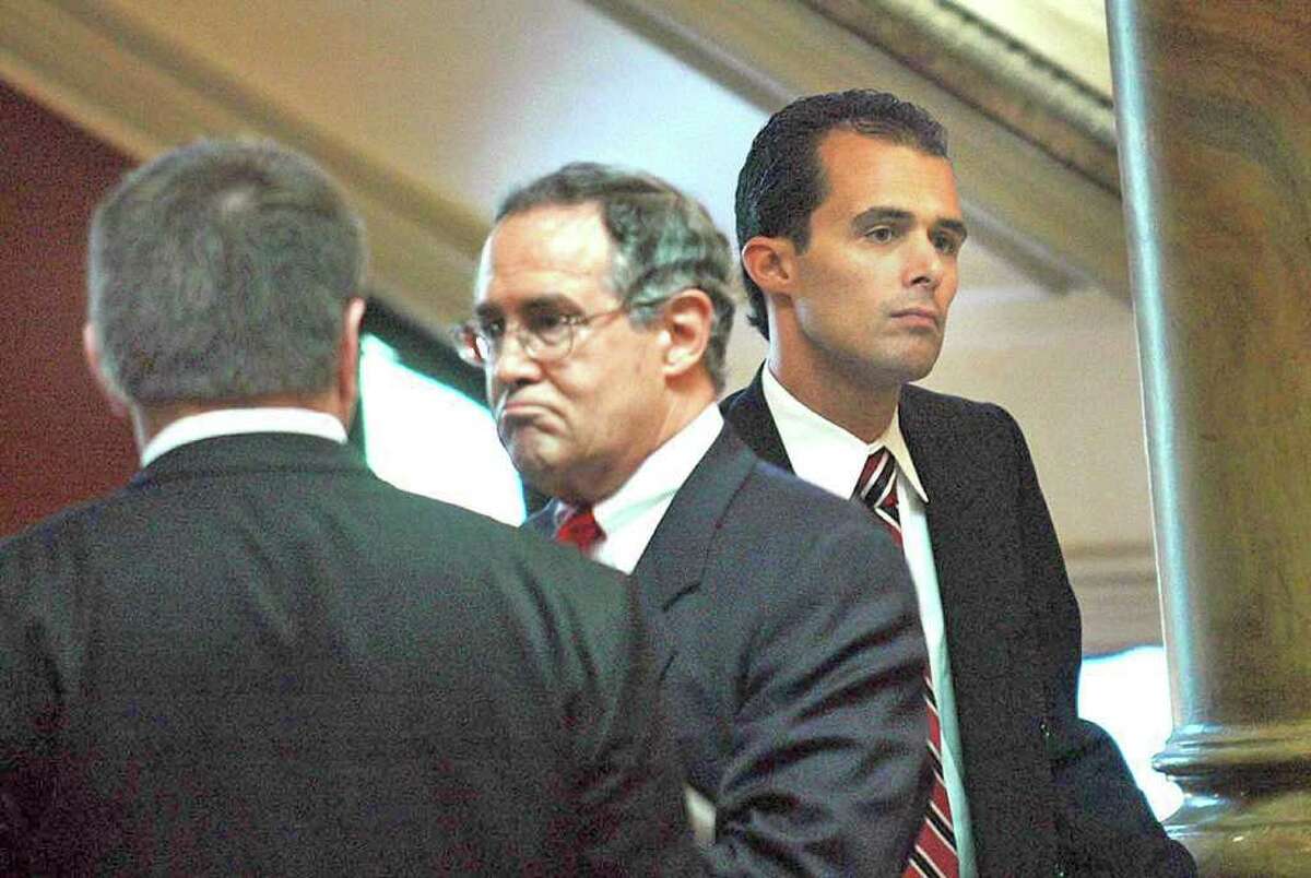 Troy Police officer Joe Centanni, right, stands after leaving the courtroom , as his lawyer, E. Stewart Jones,center, speaks with an unidentified man during a court case against Jason Jones who claims he was not given the opportunity to get a lawyer during his arrest at the Renselaer County Courthouse, Friday, September 8, 2006. (Times Union Archive)