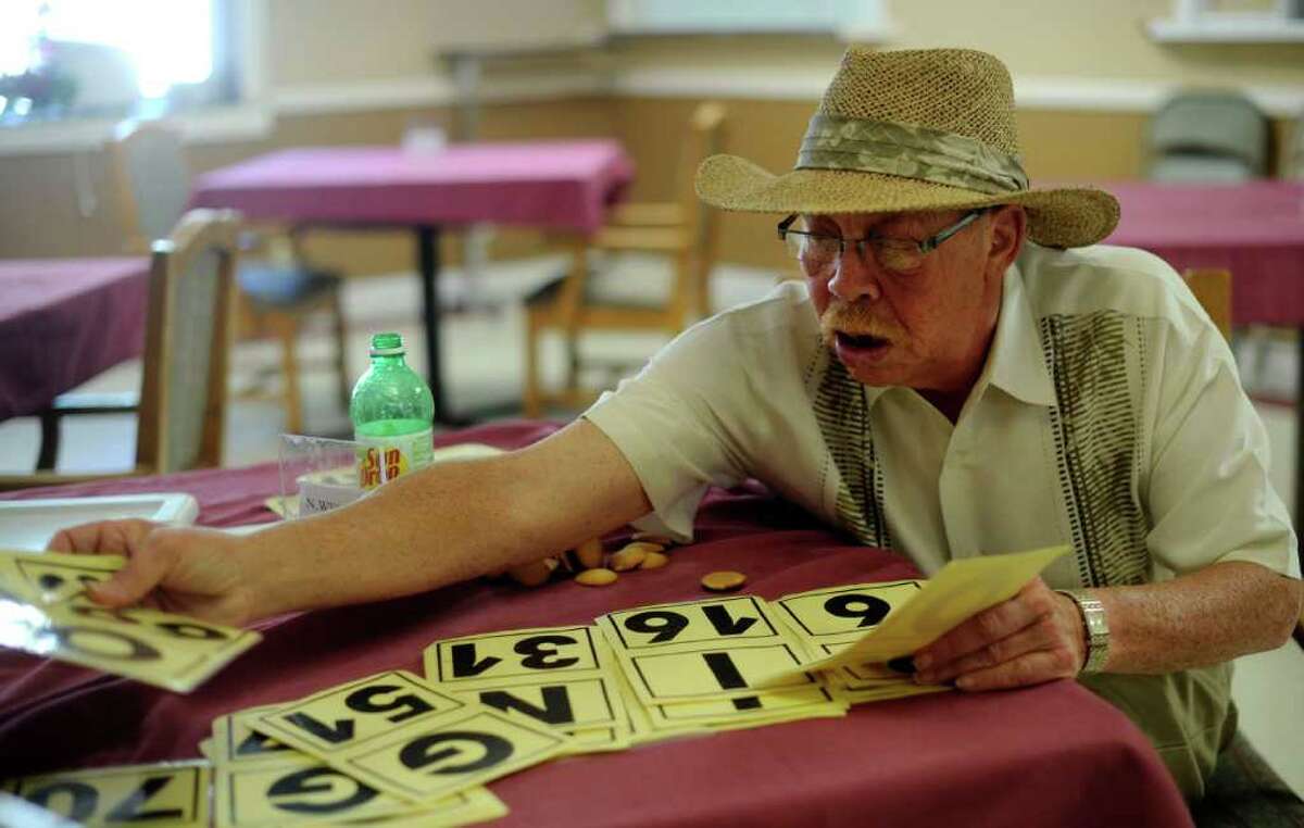 Jerry Holmes organizes cards during a game of Bingo for seniors at Stonebrook Manor on Wednesday, April 6, 2011. BILLY CALZADA / gcalzada@express-news.net vince davis story