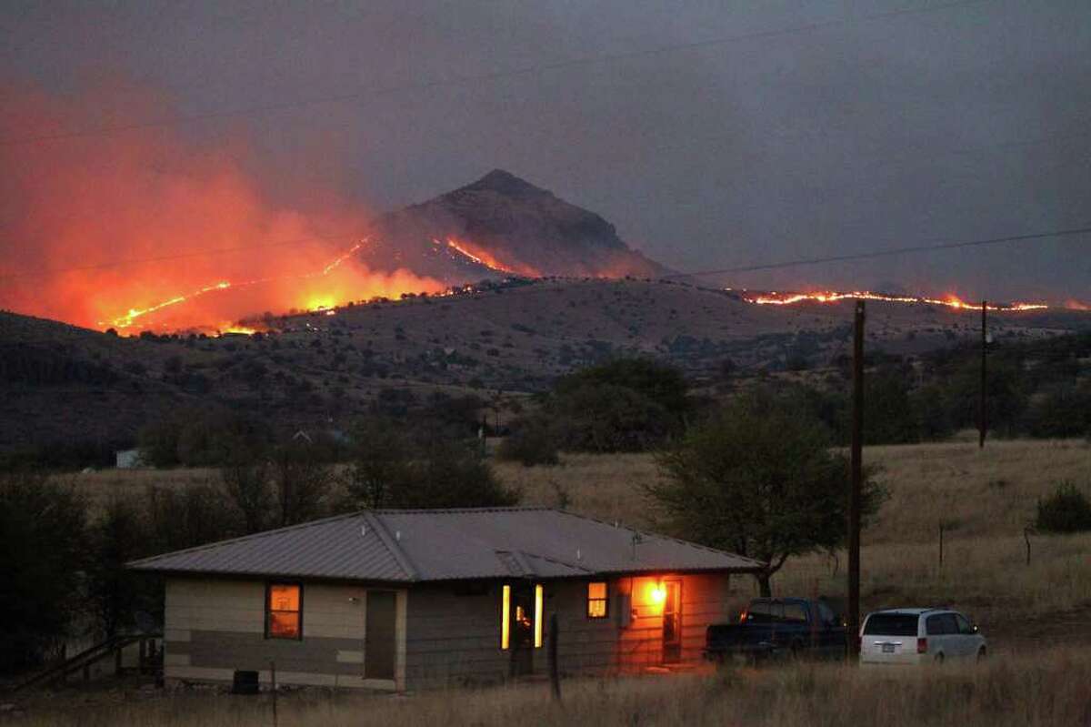 A wildfire burns on State Highway 118 near the McDonald Observatory not far from Ft. Davis, Texas. Wildfires have been buring out of control in West Texas since Saturday. JOHN DAVENPORT/jdavenport@express-news.net