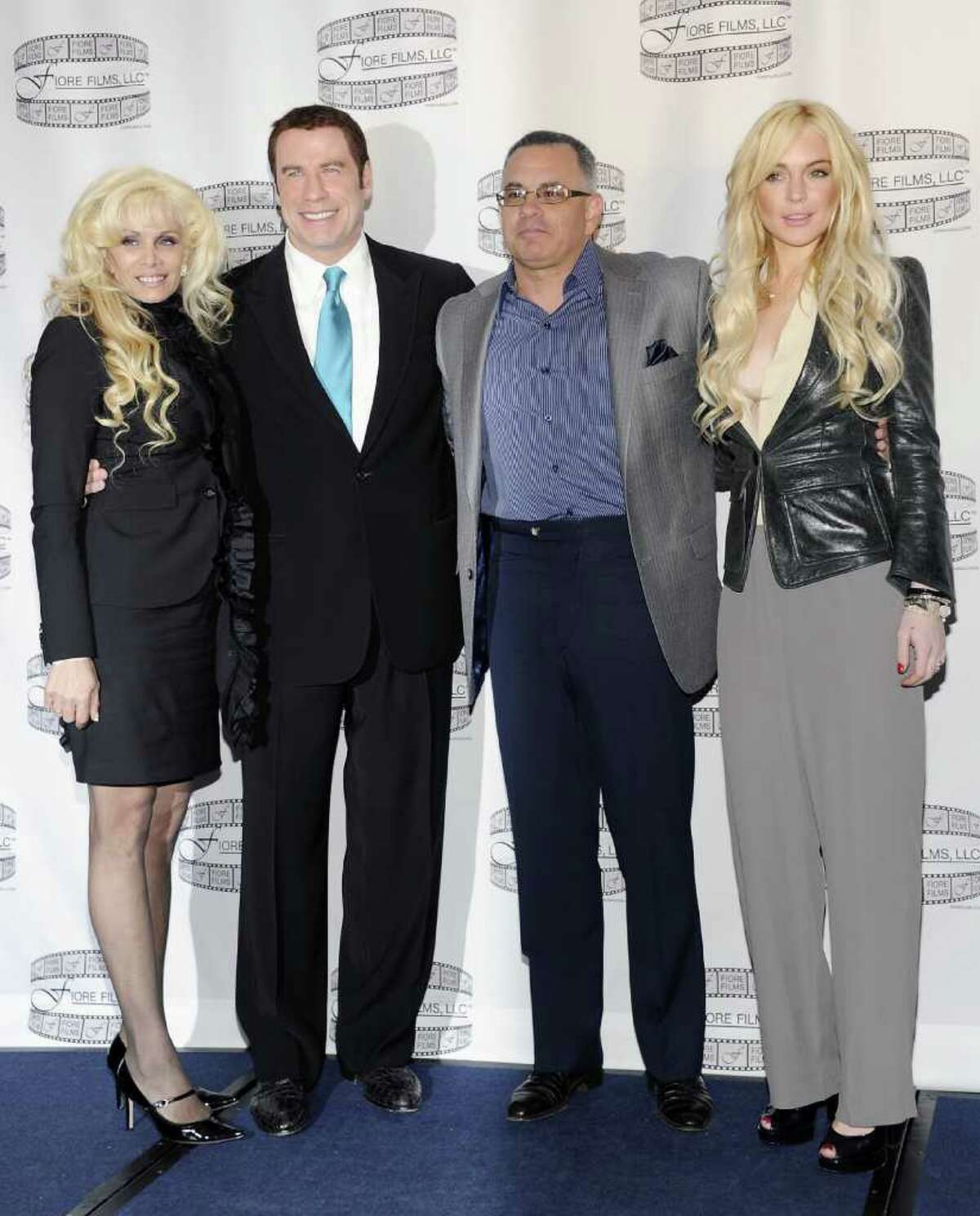 Victoria Gotti, author and daughter of the late John Gotti, left, actor John Travolta, John Gotti Jr. and actress Lindsay Lohan pose during a news conference for the film "Gotti: Three Generations", based on the life of John Gotti, at The Sheraton Hotel on Tuesday, April 12, 2011 in New York. (AP Photo/Evan Agostini)