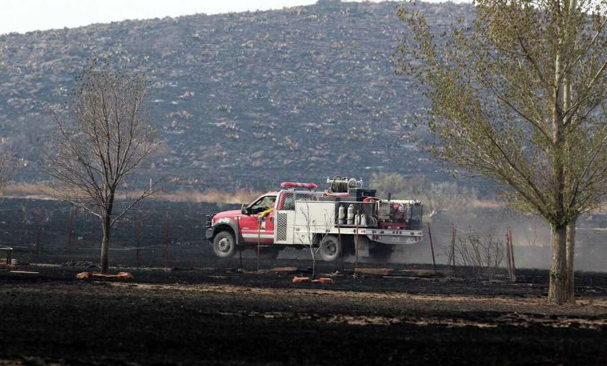 A brush truck checks for hot spots Tuesday April 12, 2011, near Fort Davis after wildfires swept through the area charring thousands of acres of land and destroying 25 structures in Fort Davis and two homes in Marfa.