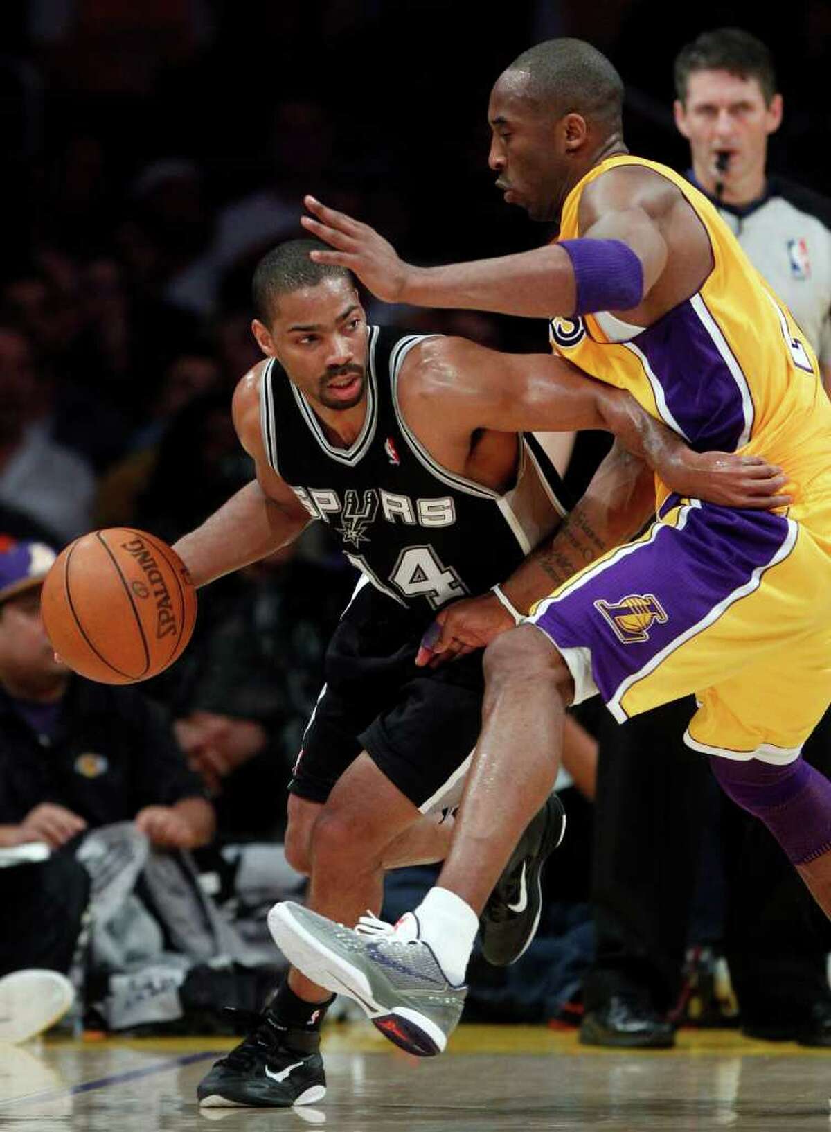 San Antonio Spurs' Gary Neal, left, drives around Los Angeles Lakers' Kobe Bryant during the first half of an NBA basketball game in Los Angeles, Tuesday, April 12, 2011.