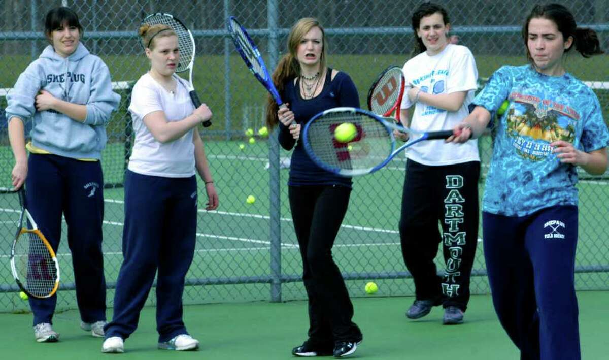 SPECTRUM/McKayla Sturges drills a forehand return during Shepaug Valley High School girls' tennis practice as, from left to right, Emily Deanne, Elyse Andrews, Maddie DeGrazia and Kathryn Paul wait their turn. April 2011