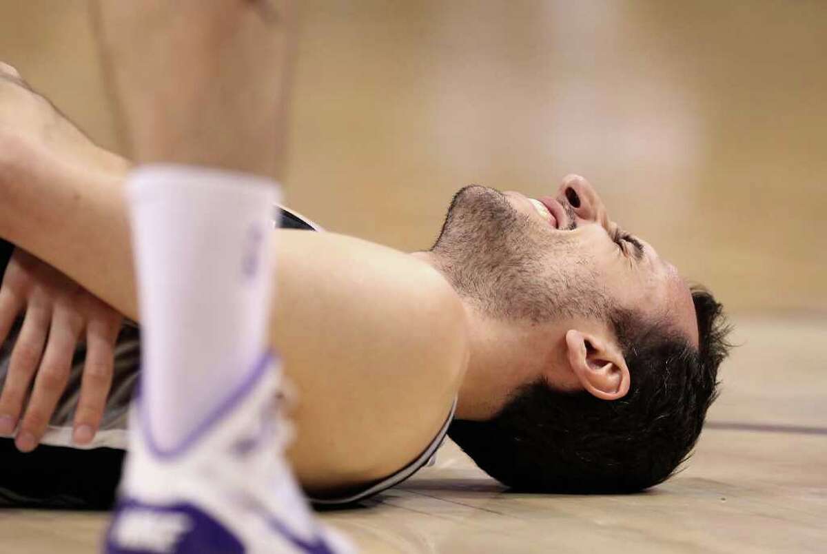PHOENIX, AZ - APRIL 13: Manu Ginobili #20 of the San Antonio Spurs reacts after an injury in the NBA game against the Phoenix Suns at US Airways Center on April 13, 2011 in Phoenix, Arizona. NOTE TO USER: User expressly acknowledges and agrees that, by downloading and or using this photograph, User is consenting to the terms and conditions of the Getty Images License Agreement. (Photo by Christian Petersen/Getty Images) *** Local Caption *** Manu Ginobili