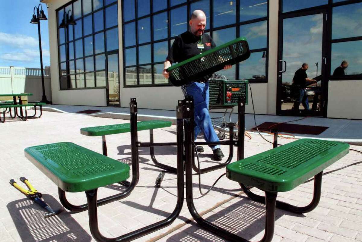 Fairway employee Kevin Scalise puts together outdoor seating at the Stamford, Conn. store on Thursday April 14, 2011, he is one of the people hired as part of a program with St. Luke's that seeks to help clients who have struggled with joblessness and homelessness.