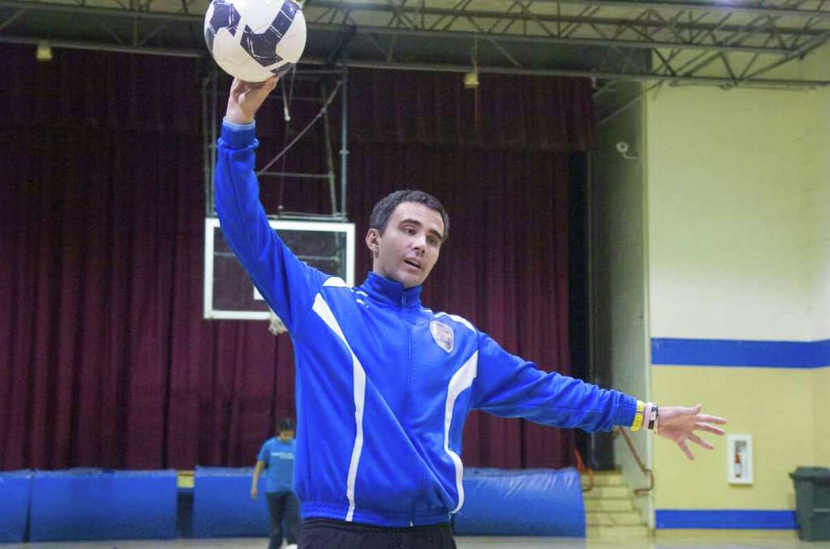 Professional soccer player Keith Donahue teaches kids how to hone their ball skills at the Chester Addison Community Center in Stamford, Conn., April 14, 2011. Donahue took off from San Diego in February on a 50-state tour performing one volunteer act in each state during his trek. For his Connecticut stop he chose to help DOMUS for the day. After spending the morning shelving books and reading to kids he ran a soccer workshop for the students for the afternoon.