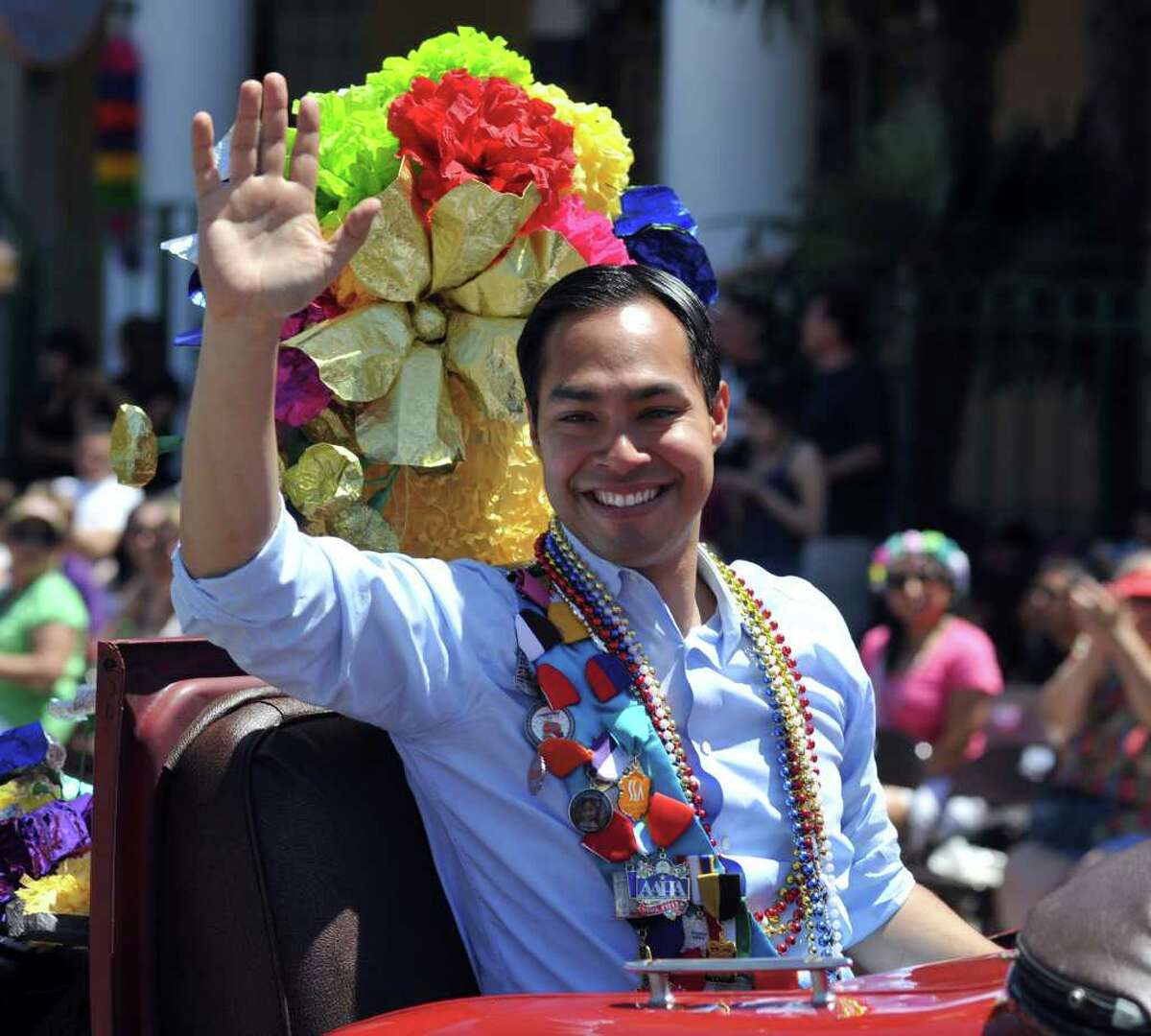SLUG: BOF2011RJ-No Photo Request number-April 15, 2011-San Antonio, Texas---Mayor Julan Castro waves to the crowd while traveling down Broadway St. during the Battle of the Flowers Parade 4/15. Photo by Robin Jerstad/Special to the Express-News