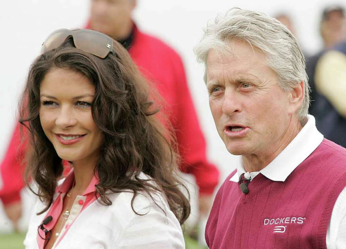 Actress Catherine Zeta Jones, left, and her husband, actor Michael Douglas, pose for a photo during the ninth annual Michael Douglas and Friends Celebrity Golf event in Rancho Palos Verdes, Calif. in 2007. (AP Photo/Dan Steinberg)