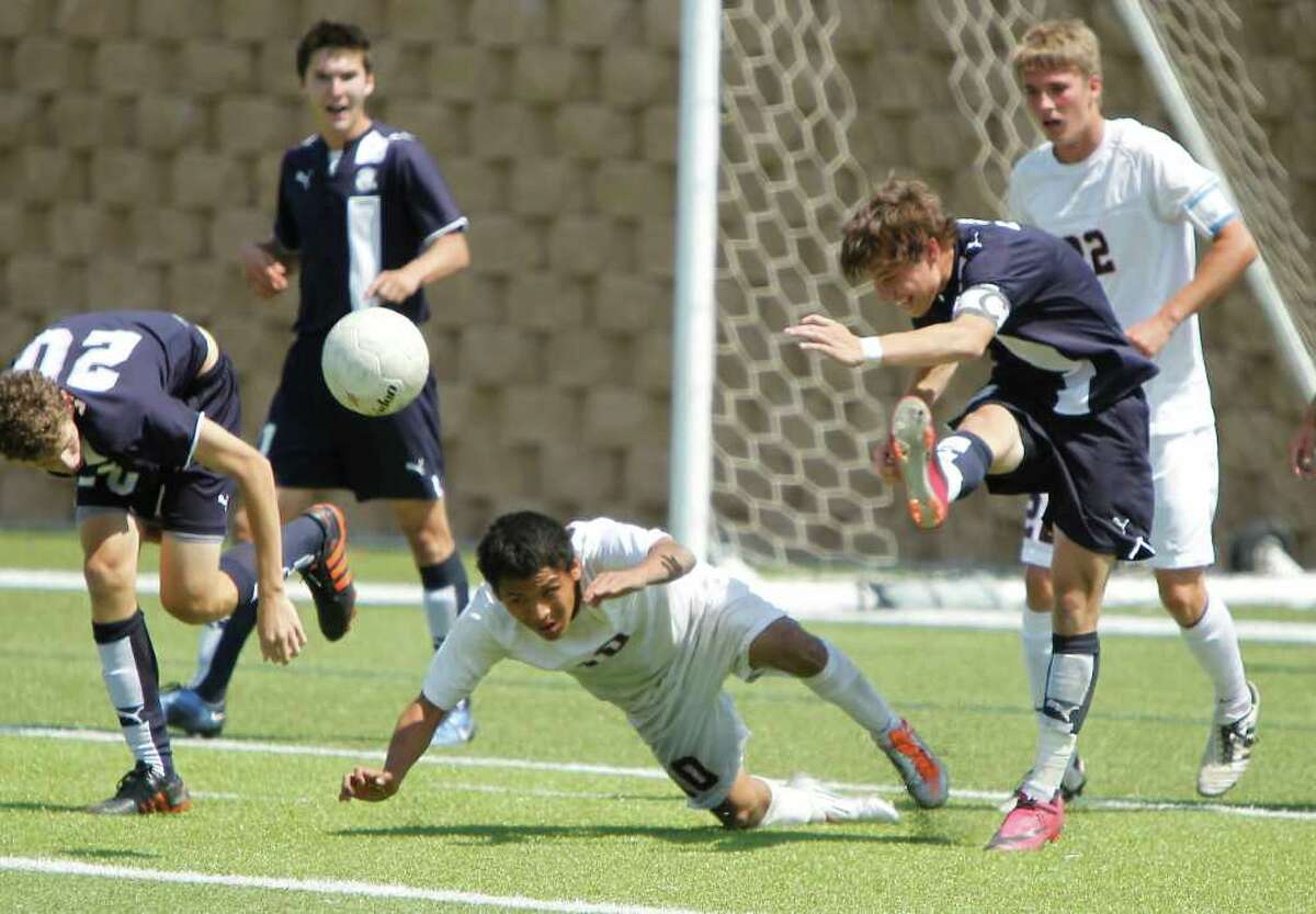 Boerne Champion midfielder Chris Schluter (8) clears the ball past Kilgore's Jose Barron (10) in the UIL Boys 4A state soccer championship in Georgetown on Saturday April 16, 2011. (Erich Schlegel/Special to the Express-News)