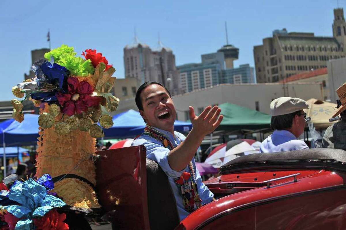metro - Mayor Julian Castro explains that he ran out of medals after spectators asked for them as he rides in the Battle of Flowers Parade on Friday, April 15, 2011. LISA KRANTZ/lkrantz@express-news.net