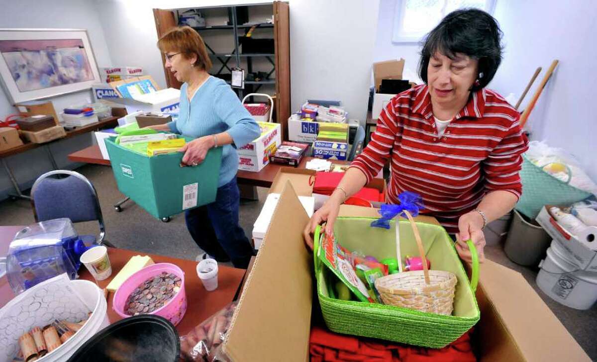 Pricilla Behling, associate director of The Volunteer Center, left, and Betty Batista, project assistant, pack for the move to the United Way offices in Danbury on Thursday. Photographed Monday, April 18, 2011.