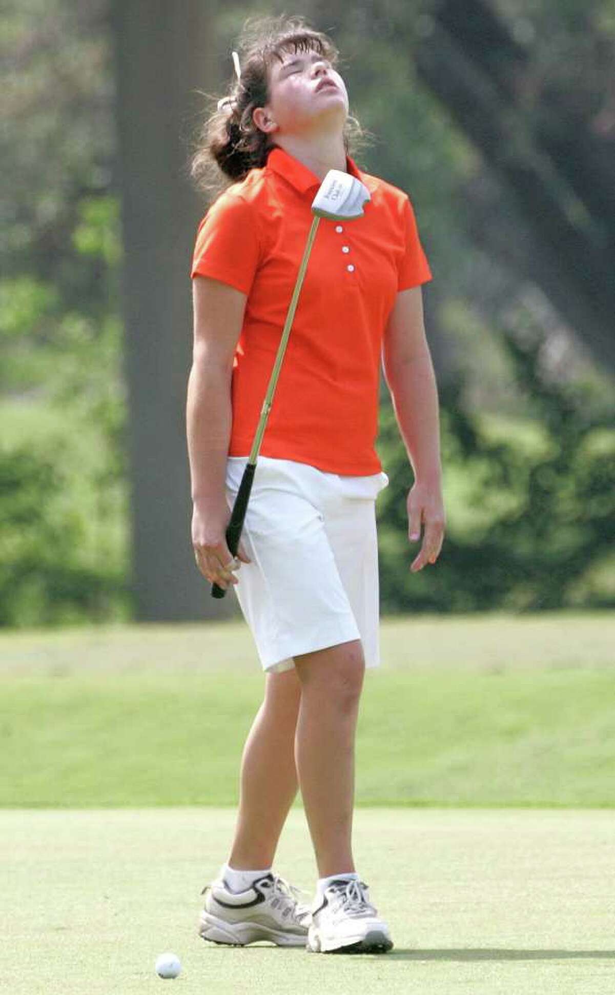 Medina Valley's Erin Noonan reacts with frustration to missing a short putt on the first hole Monday, April 18, 2011, in the first round of the Region IV-4A girls' golf tournament at Pecan Valley Golf Course.