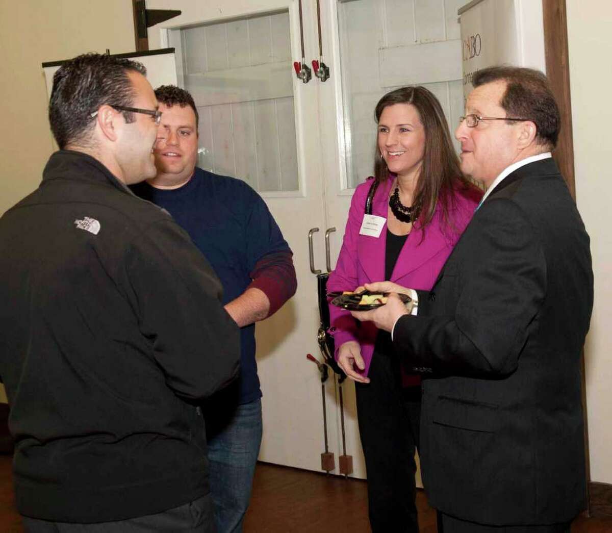 Clockwise from top, Lucas Papageorge, owner of Fairfield-based LCP General Contractors; Kristin Andree, president of Southport-based Andree Media & Consulting; Fairfield-based cosmetic dentist Joe Worthington; and chiropractor Robert Mazal talk at a Connecticut Alliance for Business Opportunities networking event on Thursday, April 14, 2011 at the Westport Country Playhouse.