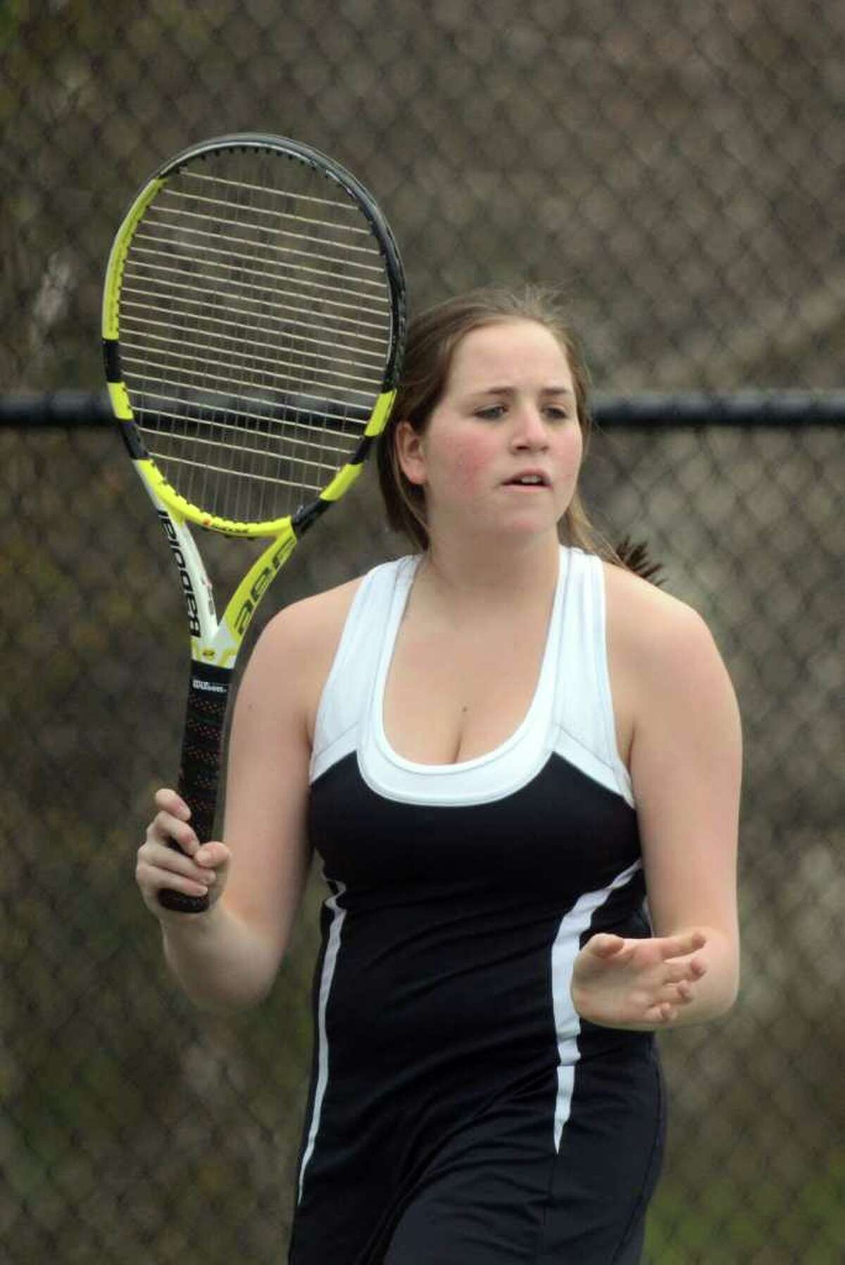 Fairfield Warde's Christie Schneider, no. 1 singles, returns the serve during the girls tennis match against Staples at Warde on Monday, Apr. 18, 2011.