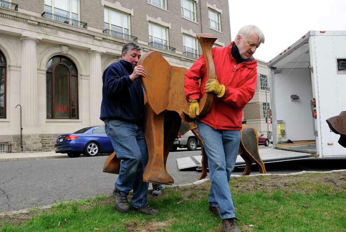 Denis Curtiss (in red), Kent, and Antonio Funseca, Stamford, carry an elephant sculpture to be displayed in front of the old town hall building on Greenwich Avenue, home to the Greenwich Arts Council, in Greenwich, CT on Tuesday, April 19, 2011. The installation is part of the Art to the Avenue project of the Greenwich Arts Council. The scuptures are the work of Curtiss.