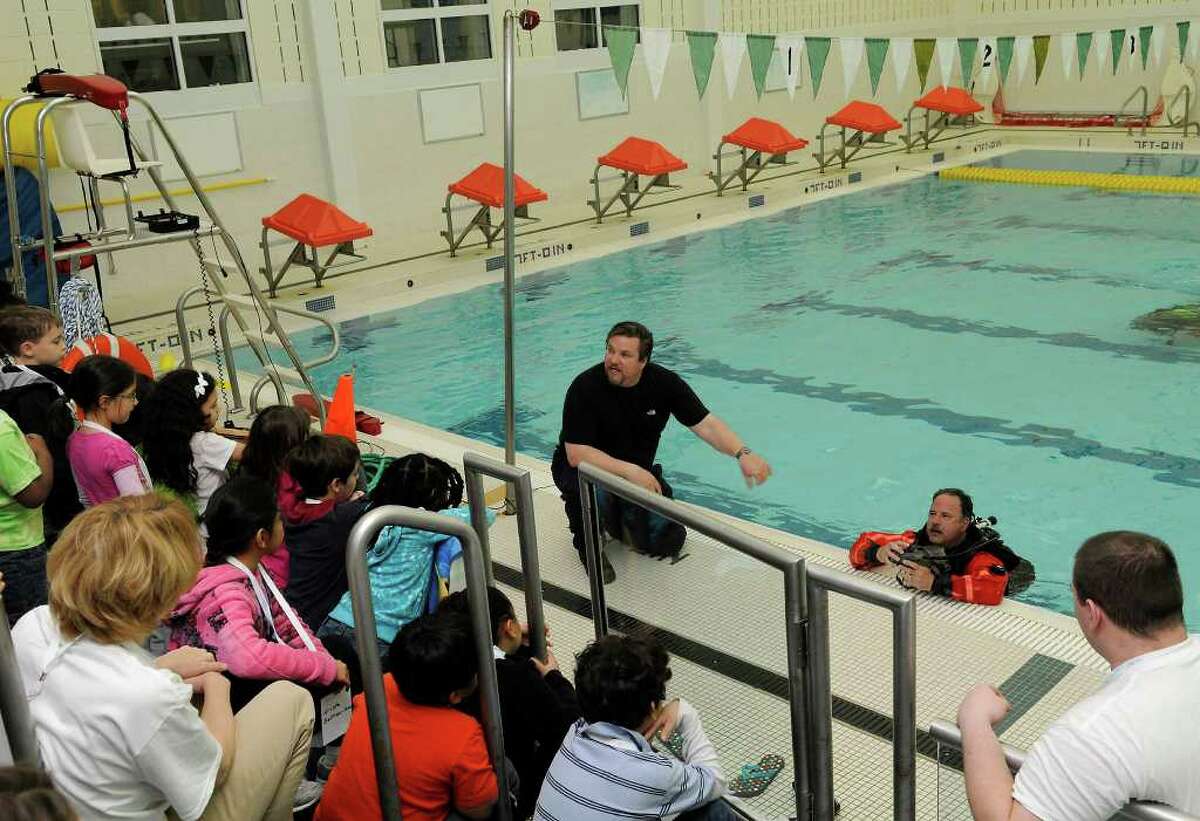 Sgt. Dave Nemecek, with the help of diver officer Dave Stewart, explains water rescue technique to dozens of campers and their parents participating in a water safety camp, a program of the ZAC Foundation, in Greenwich, CT at the Boys & Girls Club on Tuesday, April 19, 2011. Activities in the Monday-to-Friday camp include water rescue demonstrations and lessons, hands-on equipment displays, and classroom instruction. The ZAC Foundation was founded by Karen and Brian Cohn who lost their son Zachary in a pool drain entrapment. The ZAC Foundation is devoted to educating the public on the importance of water safety to ensure that no other family has to endure the loss of a child in a water-related tragedy.
