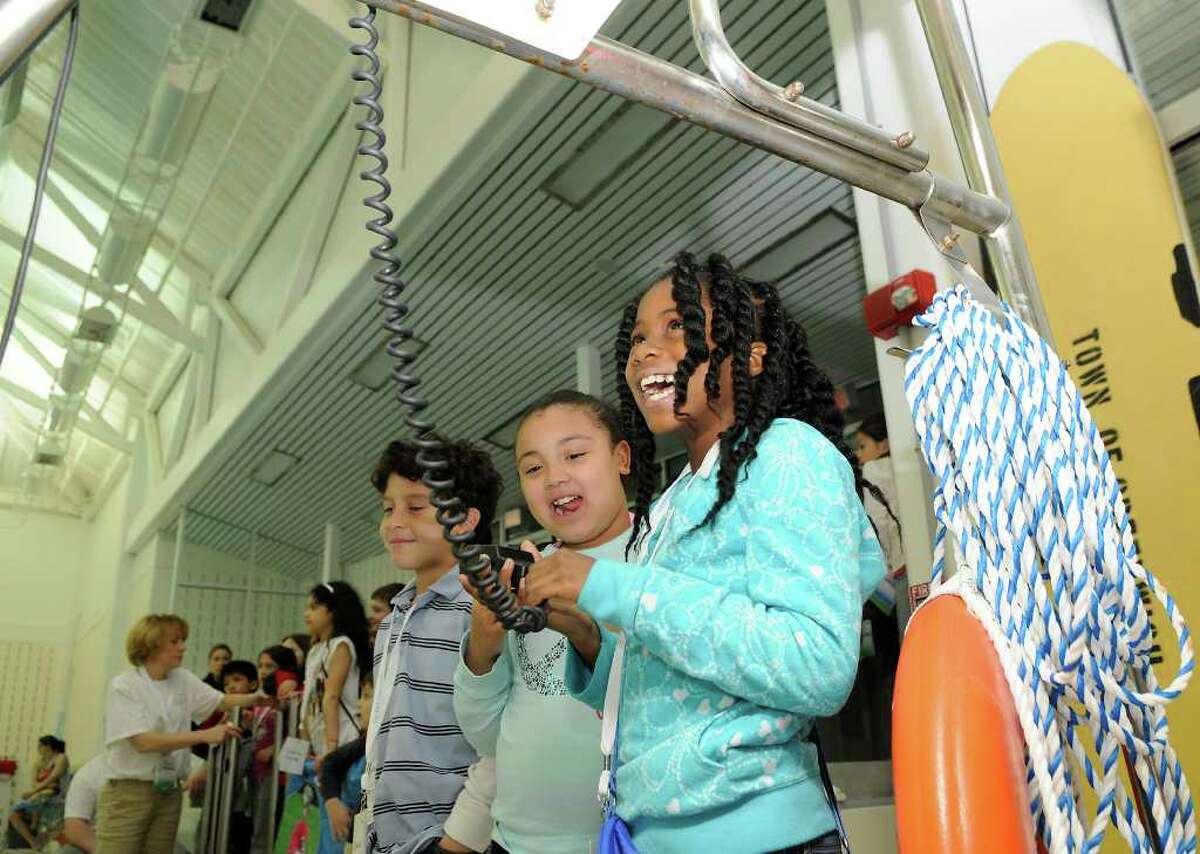 L to R: Daniel Estrella, 7, Rossy Perez, 8, and Ahhsha Crooks, 7, test out underwater communication equipment poolside at the Greenwich Boys & Girls Club. Dozens of campers and their parents participate in a water safety camp, a program of the ZAC Foundation, in Greenwich, CT at the Boys & Girls Club on Tuesday, April 19, 2011. Activities in the Monday-to-Friday camp include water rescue demonstrations and lessons, hands-on equipment displays, and classroom instruction. The ZAC Foundation was founded by Karen and Brian Cohn who lost their son Zachary in a pool drain entrapment. The ZAC Foundation is devoted to educating the public on the importance of water safety to ensure that no other family has to endure the loss of a child in a water-related tragedy.