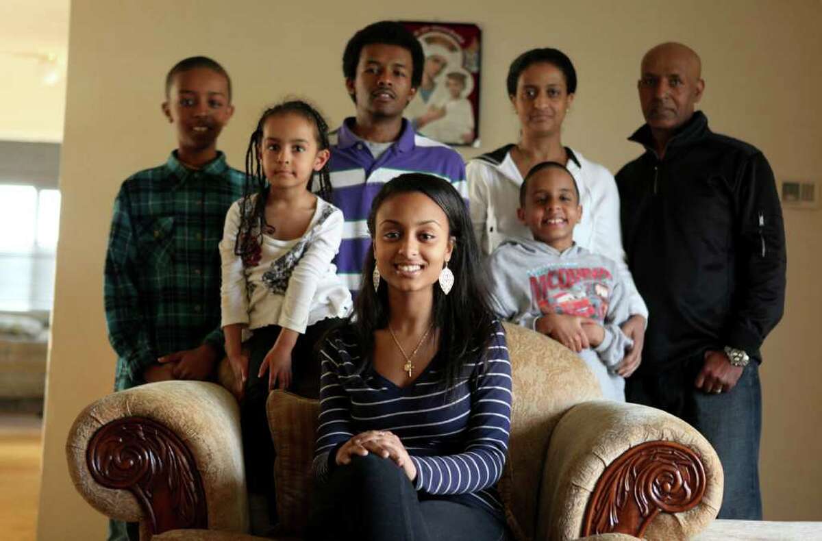 Meseret "Missy" Alemu, center, is shown with her family, from left, Abel Berhan, 11, Sarah Berhan, 4, Fasil Berhan, 17, mother Hareg Egezew, Yonathan Berhan, 9, and her father Yeshiwas Egezew. She is the first in her family to go to college and will start after high school graduation. Photographed on Wednesday, April 6, 2011 .