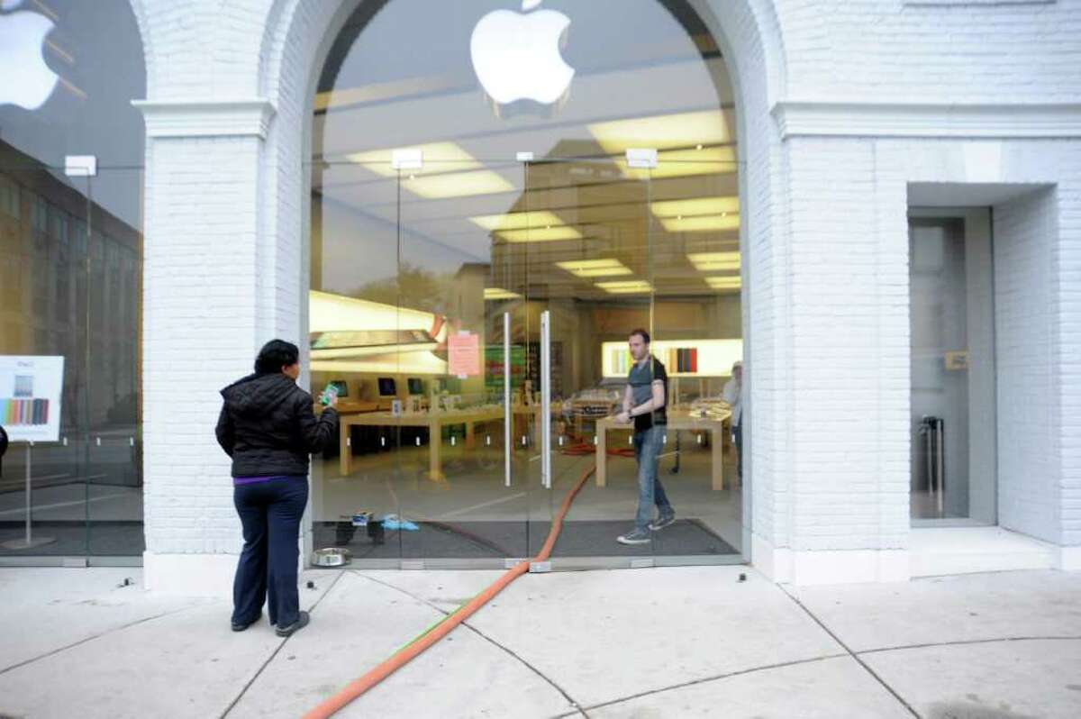 A woman comes to Apple on Greenwich Avenue to fix her iPhone Wednesday, finding that the store was closed, on April 20, 2011. The store was flooded Tuesday night when a cleaning crew damaged a sprinkler.