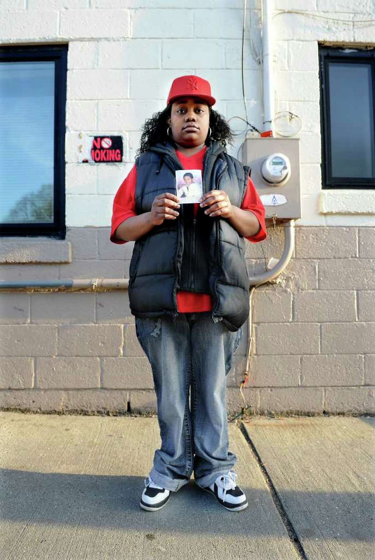 Tanya McDowell stands outside the Norwalk Emergency Shelter with a photo of her son, A.J. Paches, on Wednesday, April 20, 2011. McDowell, who is homeless and lives in her van, was arrested after enrolling her son in the Norwalk City School District.