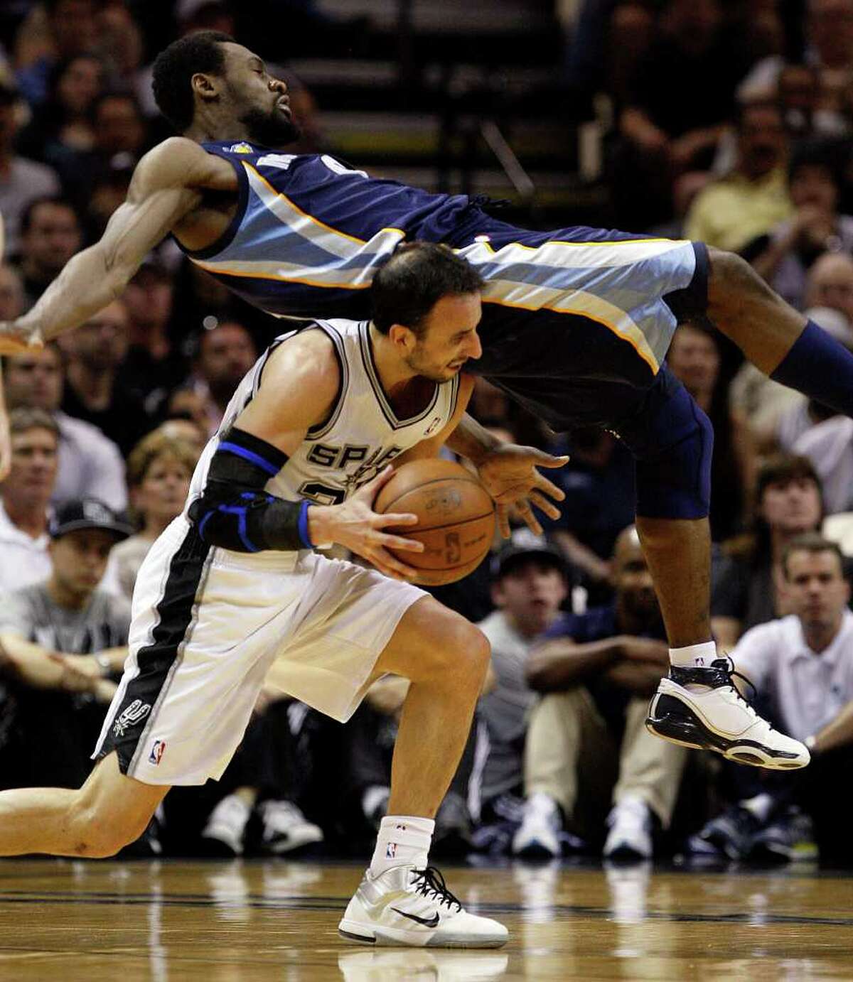 SPURS -- Memphis Grizzlies Tony Allen falls on San Antonio Spurs Manu Ginobili during the first half in the second game of the Western Conference Quarter Finals at the AT&T Center, April 20, 2011. JERRY LARA/glara@express-news.net