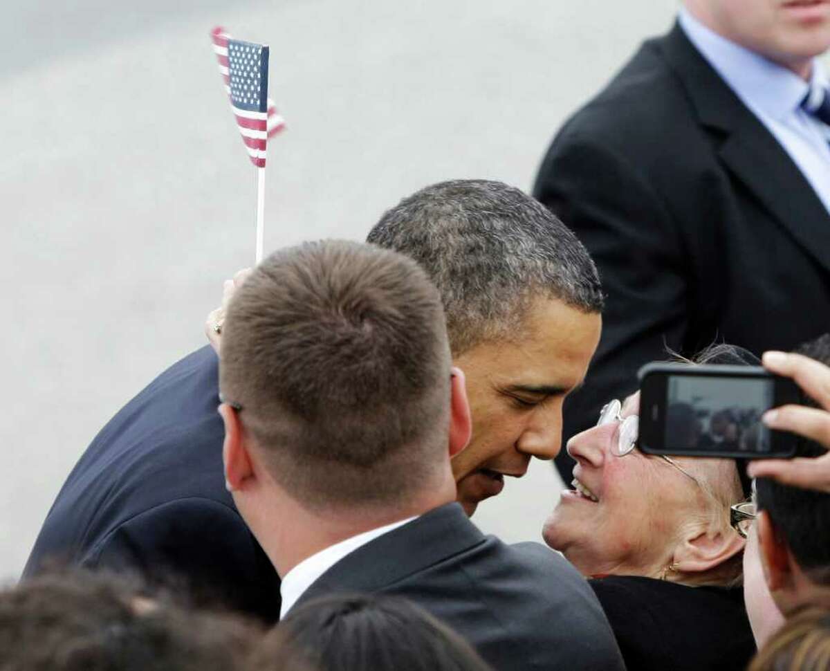 President Obama receives a kiss from Odette Etcheverry, 76, of San Francisco, as he arrives at San Francisco International Airport, Wednesday, April 20, 2011, for a planned meeting at Facebook headquarters.