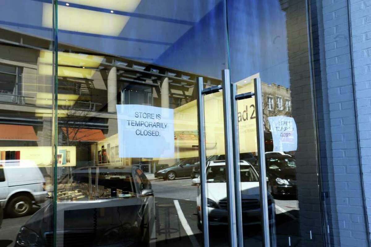 Signs hung on the door at the Apple computer store on Greenwich Avenue notifying customers that the store is temporarily closed on Wednesday, April 20, 2011. The store was flooded Tuesday night when a cleaning crew damaged a sprinkler.