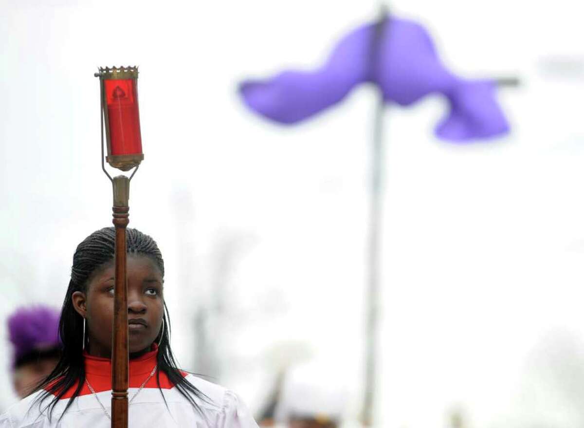 Seventeen-year-old Christina Chery, from St. Charles Borromeo Roman Catholic Church, takes part in a procession through the East Side of Bridgeport, Conn. on Good Friday, April 22, 2011.