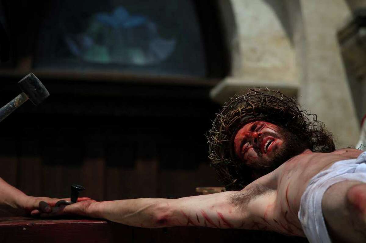 Jesus, played by Bruno Horwath, is nailed to the Cross in front of San Fernando Cathedral during the Passion Play on Friday, April 22, 2011. LISA KRANTZ/lkrantz@express-news.net
