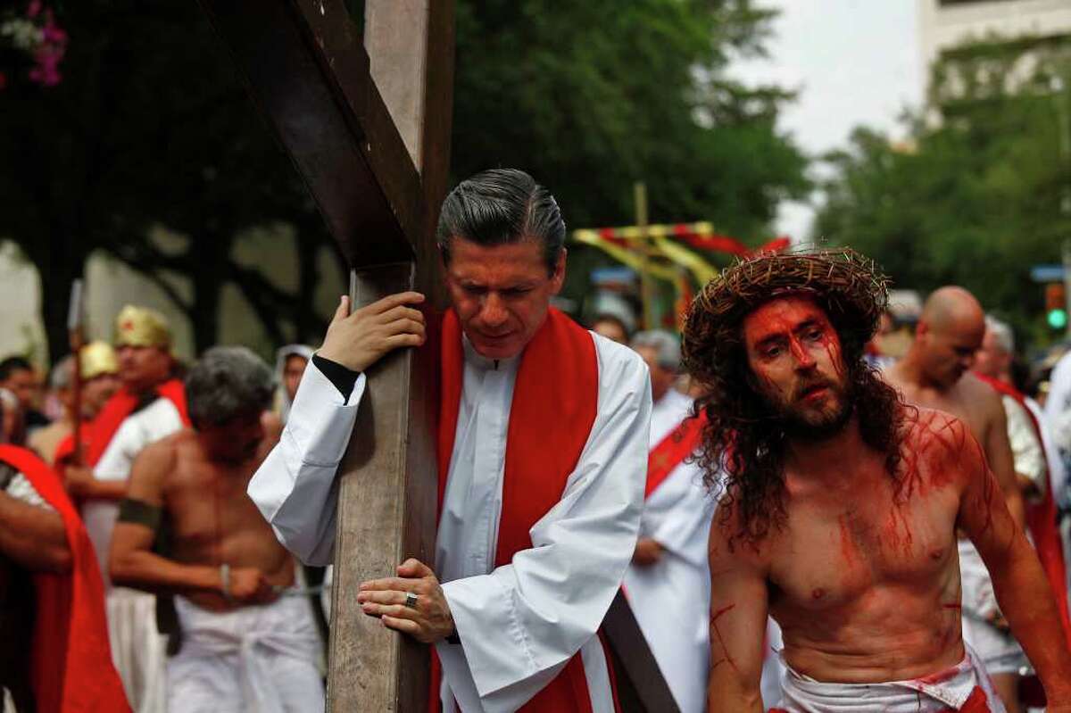 San Antonio Archbishop Gustavo Garcia-Siller takes his turn carrying the cross as he walks with Bruno Horwath, right, as Jesus, during the Passion Play on Friday, April 22, 2011. LISA KRANTZ/lkrantz@express-news.net