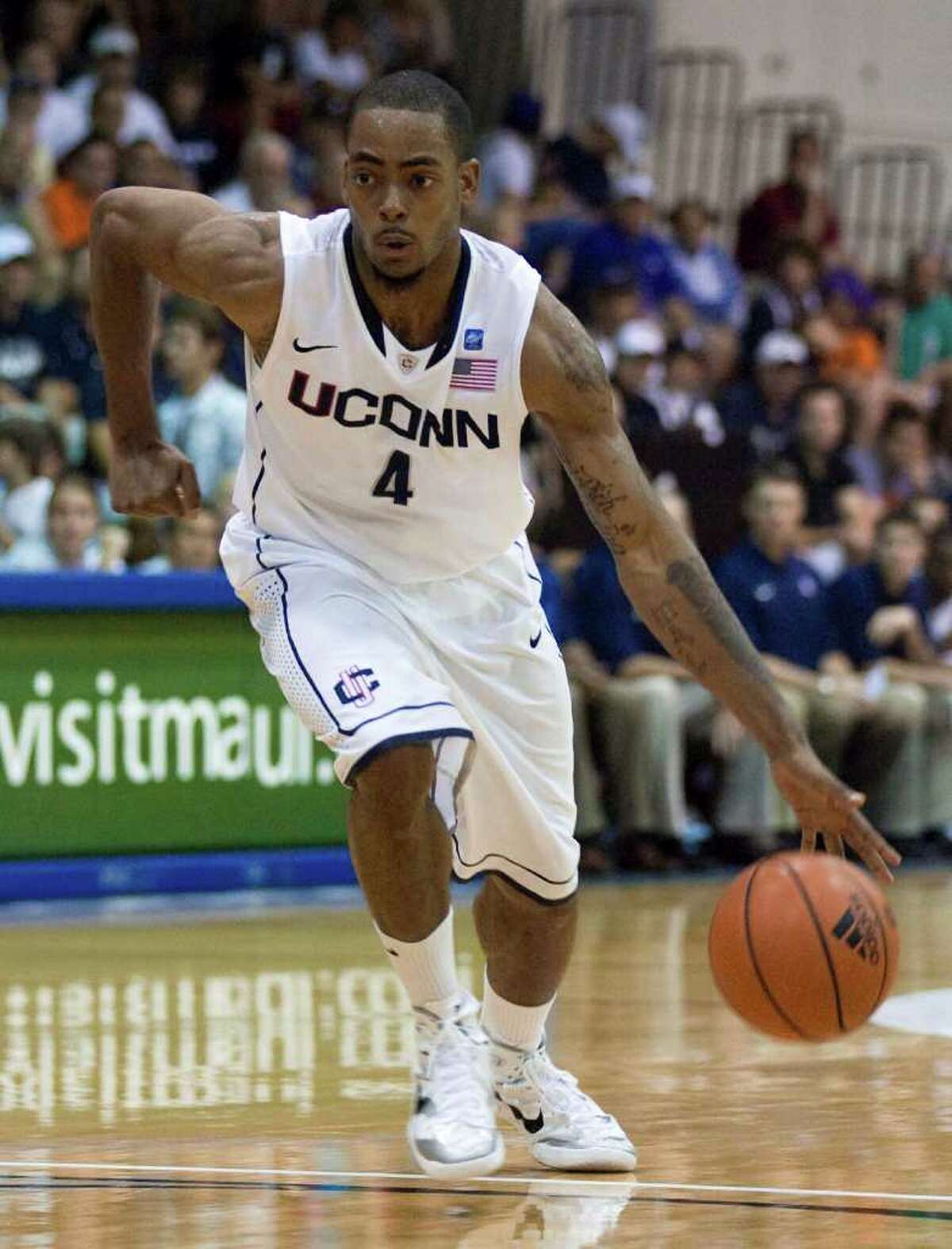 FILE - In this Nov. 22, 2010 file photo, Connecticut forward Jamal Coombs-McDaniel (4) looks for an opening in the Wichita State defense during an NCAA college basketball game at the Maui Invitational in Lahaina, Hawaii. UConn campus police say the sophomore was arrested Thursday night, April 21, 2011, with two other people. He was charged with possession of more than four ounces of marijuana and possession of drug paraphernalia. Police say the three had 5.6 ounces of the drug. (AP Photo/Eugene Tanner, File)