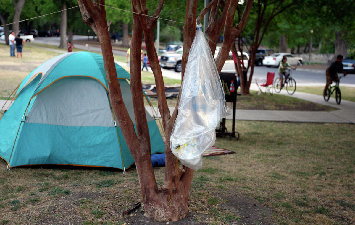 A recycling bag hangs from a tree on April 22 at Brackenridge Park as people camp for the Easter weekend.