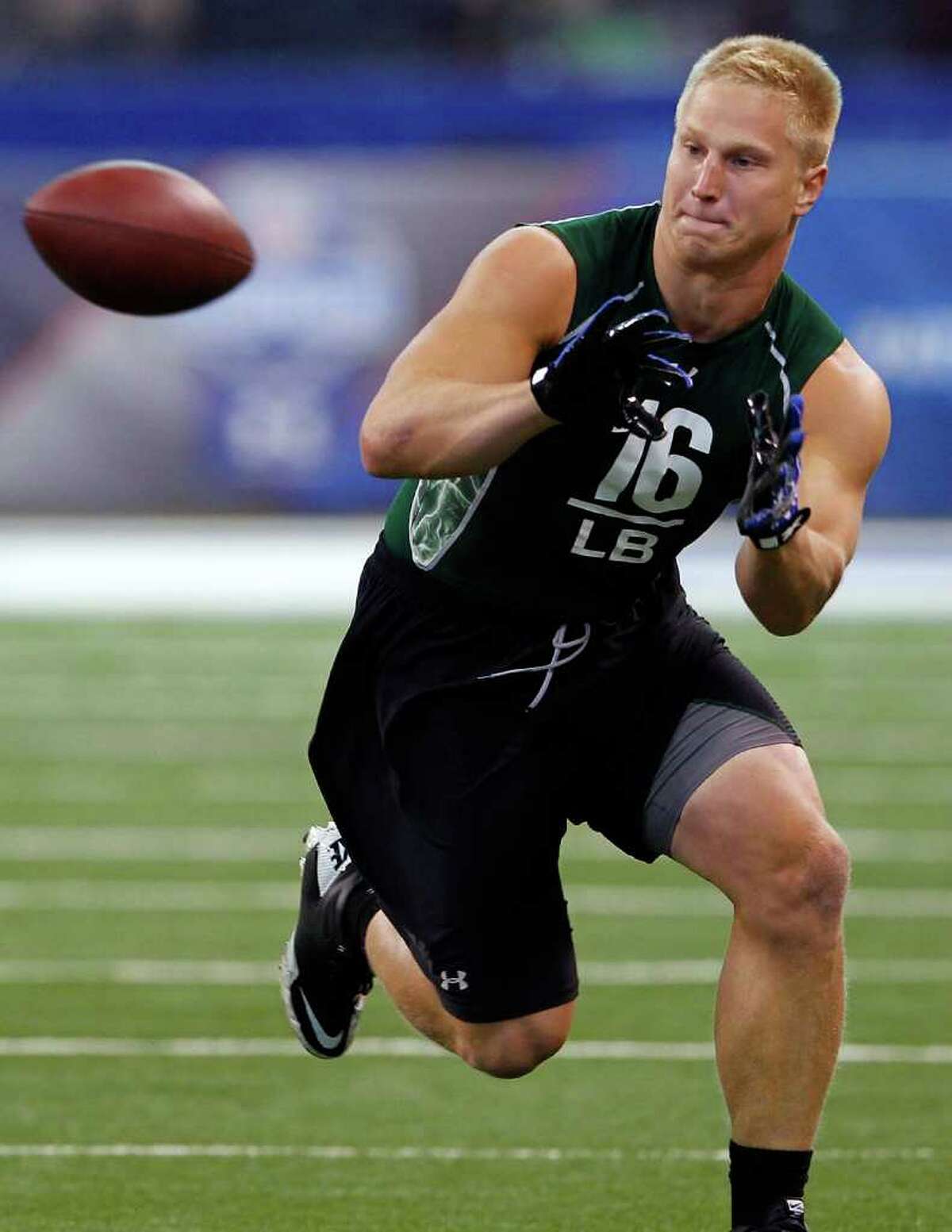 Connecticut linebacker Scott Lutrus catches a pass during the 2011 NFL Scouting Combine at Lucas Oil Stadium on Feb. 28 in Indianapolis, Ind. (AP Photo/Ben Liebenberg)