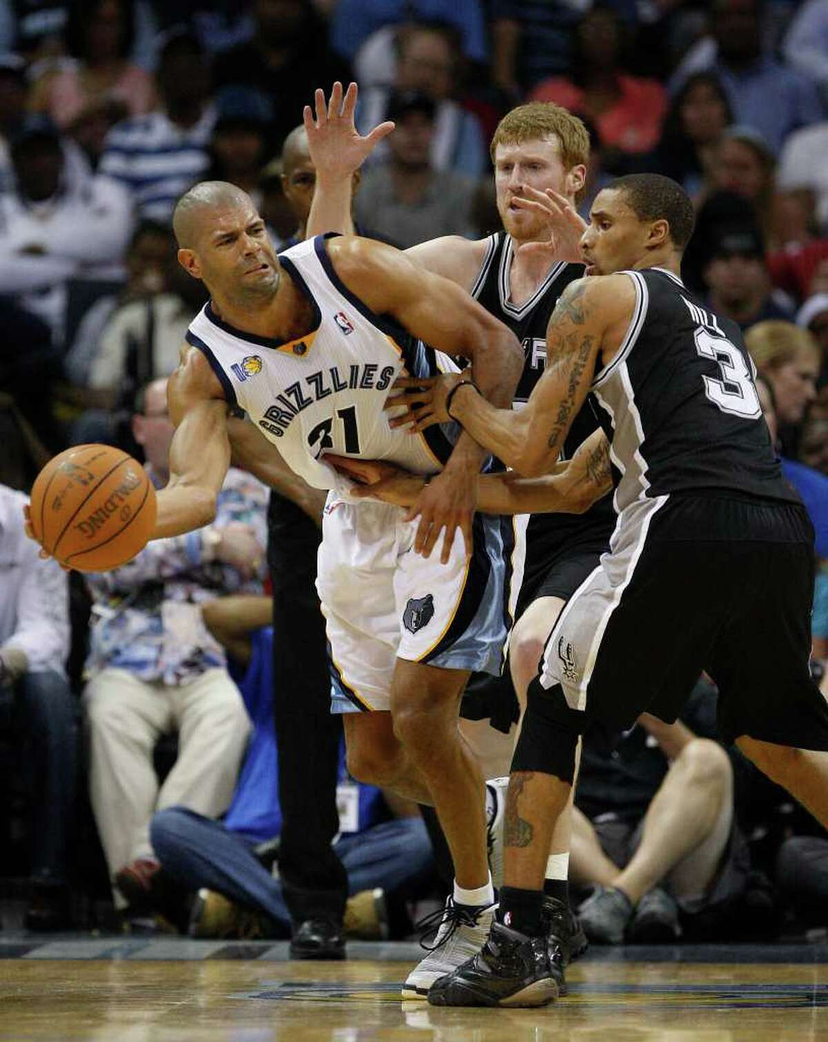 SPURS -- Memphis Grizzlies Shane Battier passes under pressure from San Antonio Spurs Matt Bonner and George Hill during the second half in the third game of the Western Conference Quarter First Round at FedExForum in Memphis, TN, April 23, 2011. The Grizzlies won 91-88 and go up 2-1 in the series. JERRY LARA/glara@express-news.net