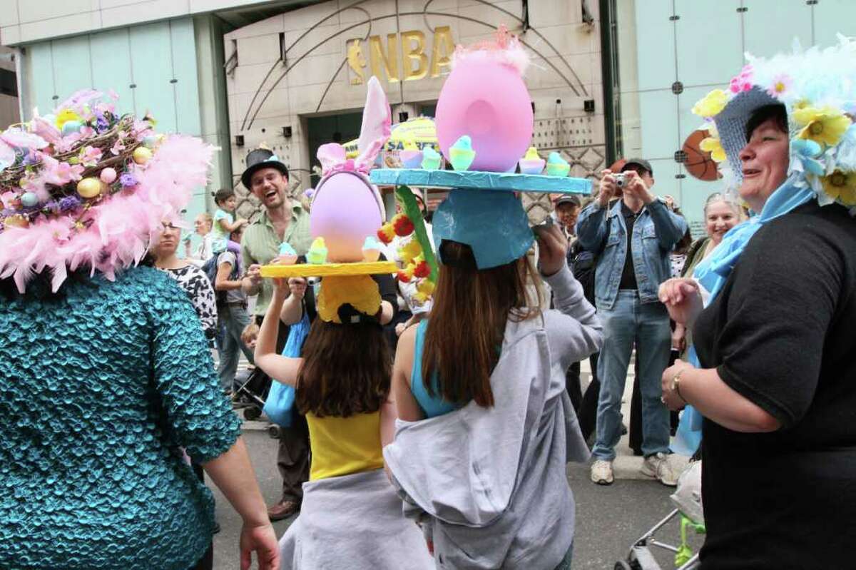 Leah, 11, foreground second from left, and her friend Rachel, 10, foreground second from right, both from New Jersey, pose for photographers with others wearing hats as they as they take part in the Easter Parade along New York's Fifth Avenue Sunday April 24, 2011. (AP Photo/Tina Fineberg)