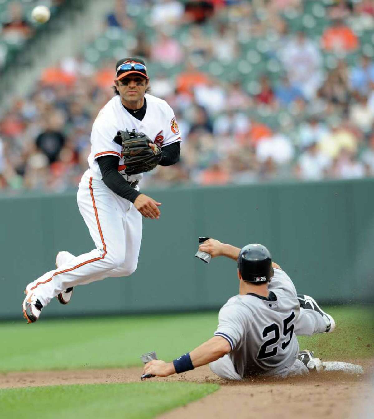 Baltimore Orioles second baseman Brian Roberts throws to first as New York Yankees' Mark Teixeira is out on a ground ball hit by Alex Rodriguez during the fifth inning of a baseball game, Sunday, April 24, 2011, in Baltimore. Rodriguez was safe at first. (AP Photo/Gail Burton)