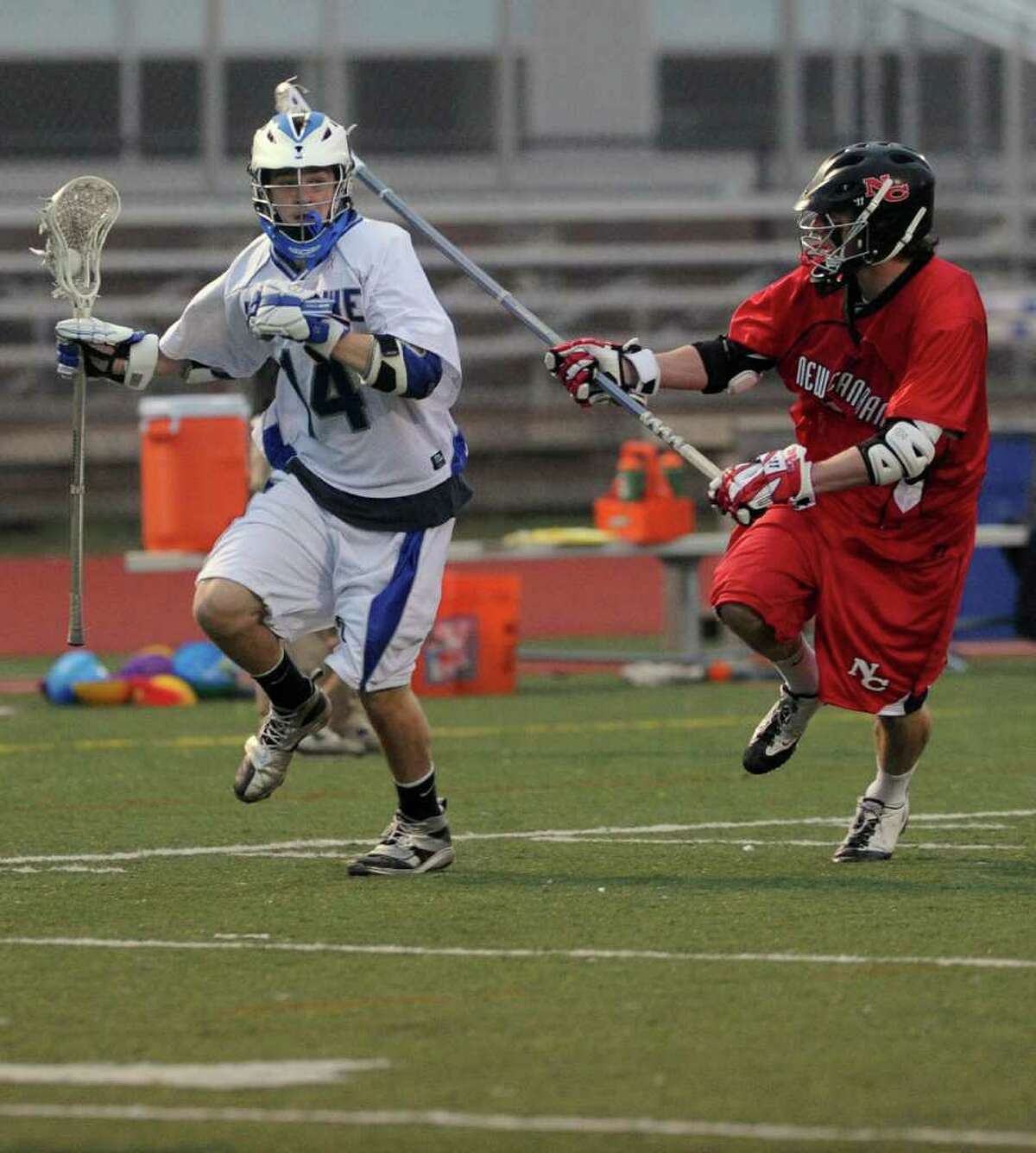 Ludlowe's Brooks Brown carries the ball as he is defended by New Canaan's Willie Gould during Wednesday's lacrosse game against New Canaan at Fairfield Ludlowe High School on April 27, 2011.