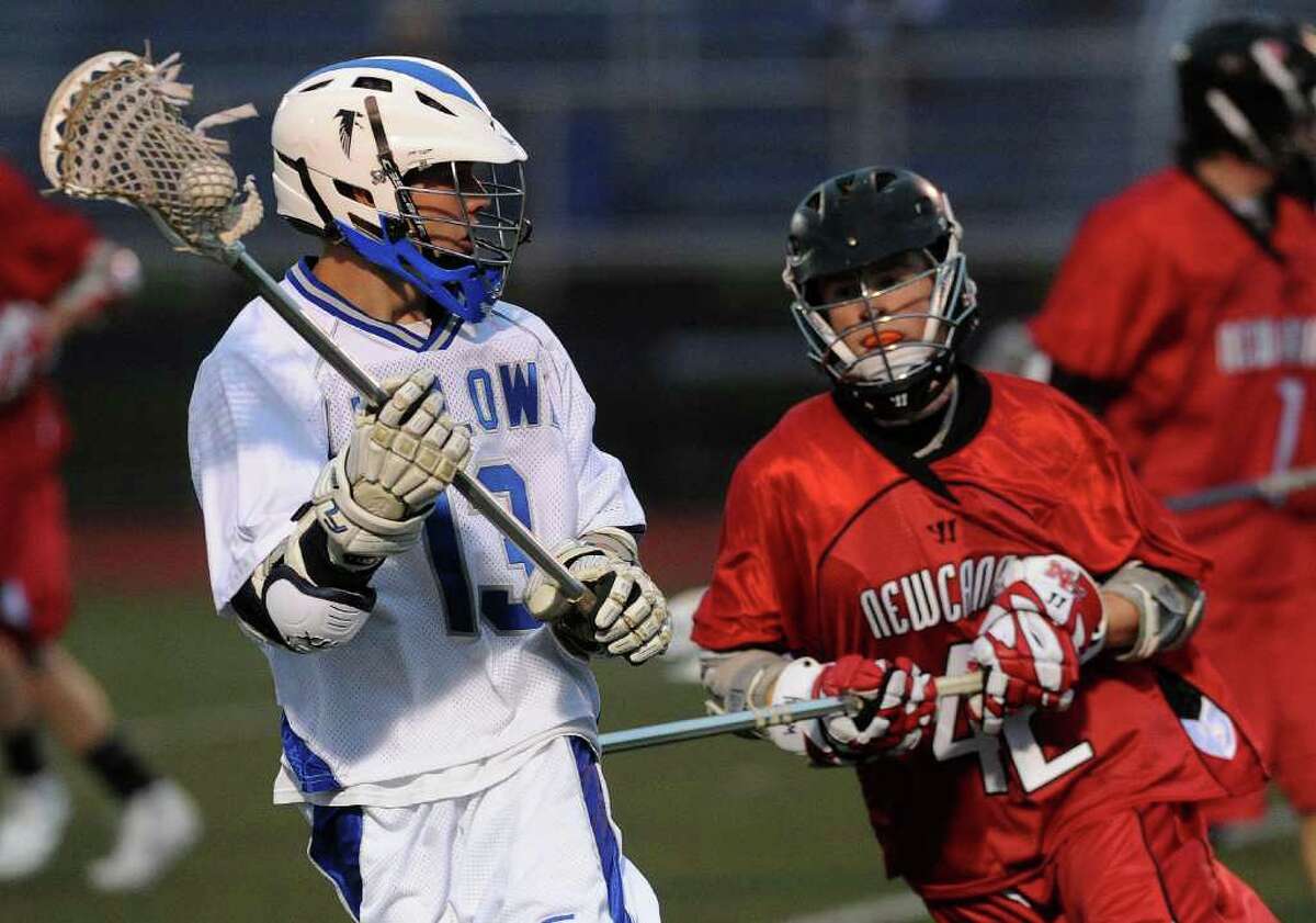 Ludlowe's Pat Nadolny carries the ball as Jake Miller defends during Wednesday's lacrosse game against New Canaan at Fairfield Ludlowe High School on April 27, 2011.