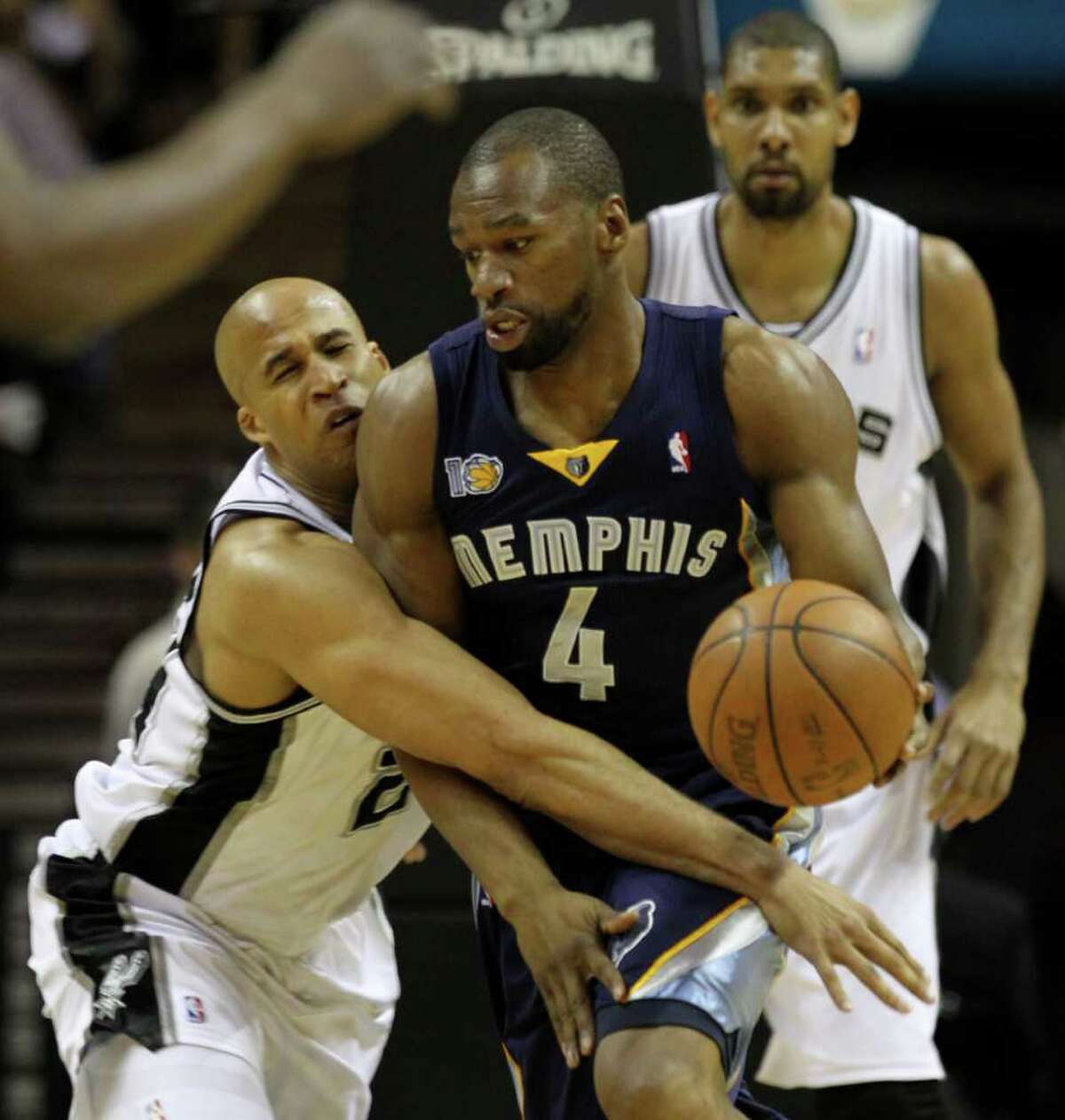 San Antonio Spurs forward Richard Jefferson (24) reaches around Memphis Grizzlies forward Sam Young (4) in Game 5 of the first round of the Western Conference playoff at the AT&T Center on Wednesday, April 27, 2011. Kin Man Hui/kmhui@express-news.net