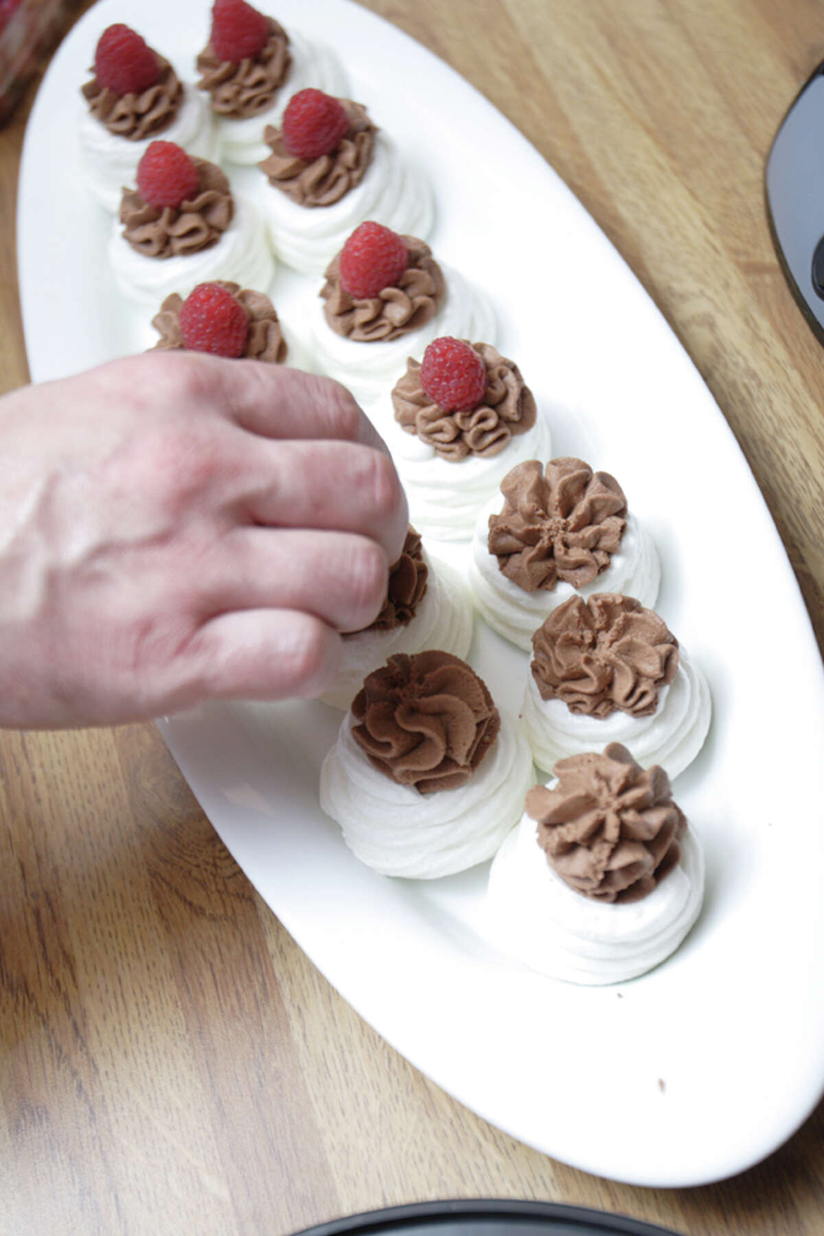 Chef Patrick Longton puts the finishing touches on his mini meringues with chocolate mousse. (Suzanne Kawola/Life@Home) Click here to read the story, and here to get the recipe.