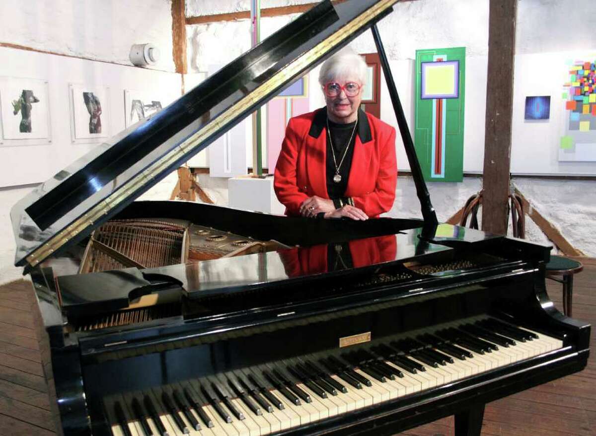 Ruth Henderson stands next to her late husband Skitch's Steinway piano known as Model B 332408 at the Silo Gallery at Hunt Hill Farm in New Milford. Photo taken April 28, 2011.