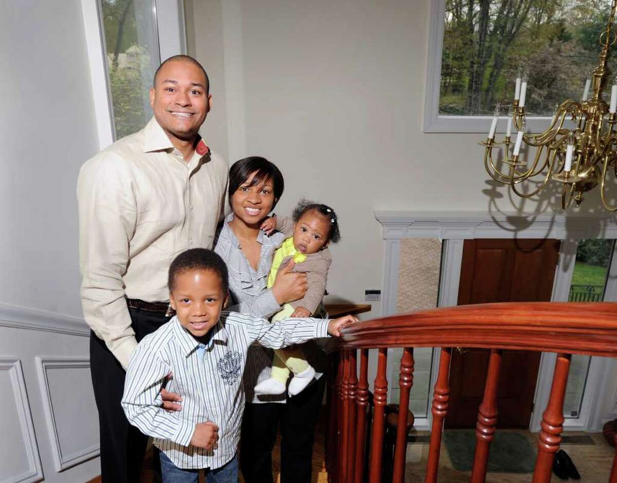 Sekou Kaalund, left, with his wife, Jennifer, and their daughter, Mikah, 8 months old, and son, Kaleb, 5, at the home they are renting in Cos Cob, Saturday morning, April 30, 2011. The Kaalunds are looking to buy a home in Greenwich.