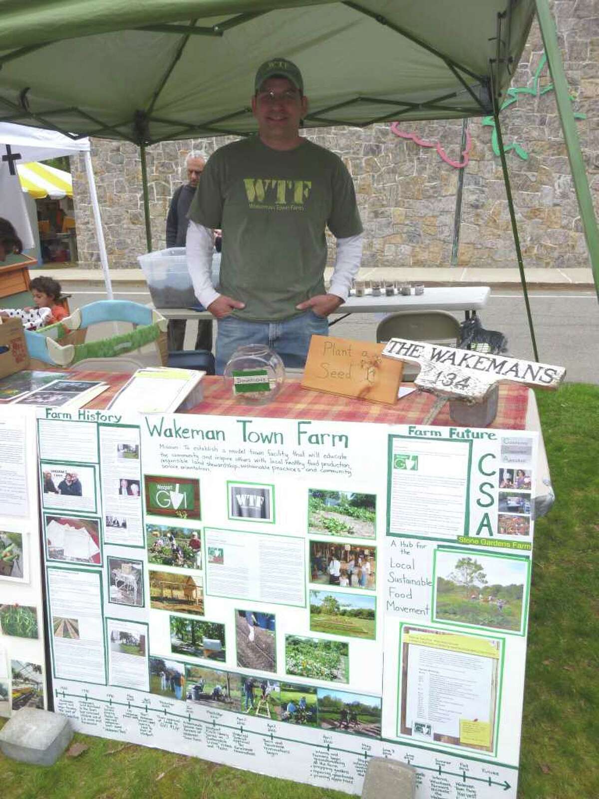 Mike Aitkenhead, of Wakeman Town Farm, said the homestead aims to be the hub of the local food movement in Westport. The farm booth was among the displays at the Green Earth Fair in Westport on Saturday.