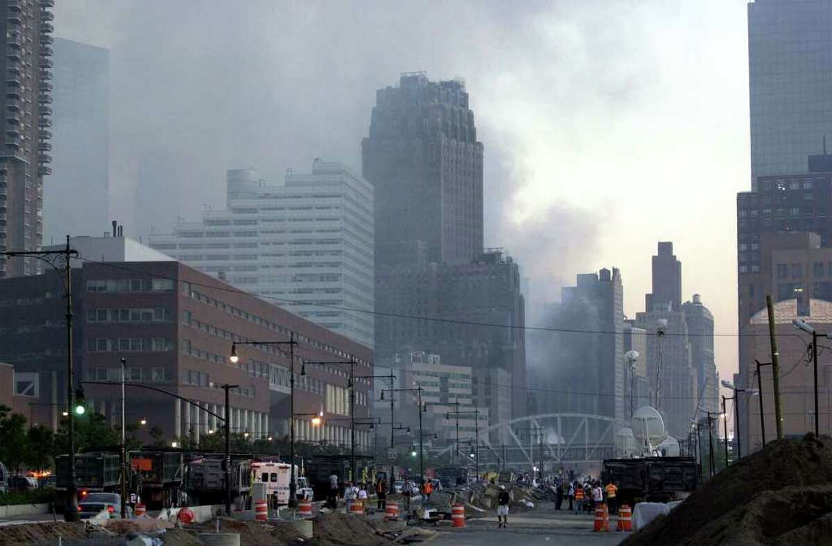 Smoke fills the air over two building that were damaged at the site of World Trade Center Bombing in New York Wednesday Sept. 12, 2001.