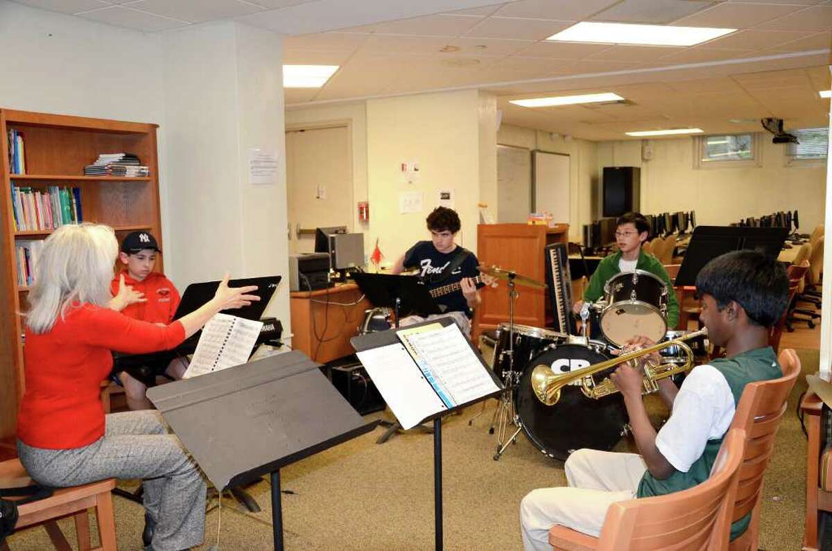 Director, Joyce DiCamillo conducts Josh Klapper of New Canaan, Connor Ackley of Darien, Lucas Fee of Darien, and Vijay Kadiyala from Greenwich during a rehearsal of The Young Peoples Jazz Ensemble at Stamford High School onMay 2, 2011.