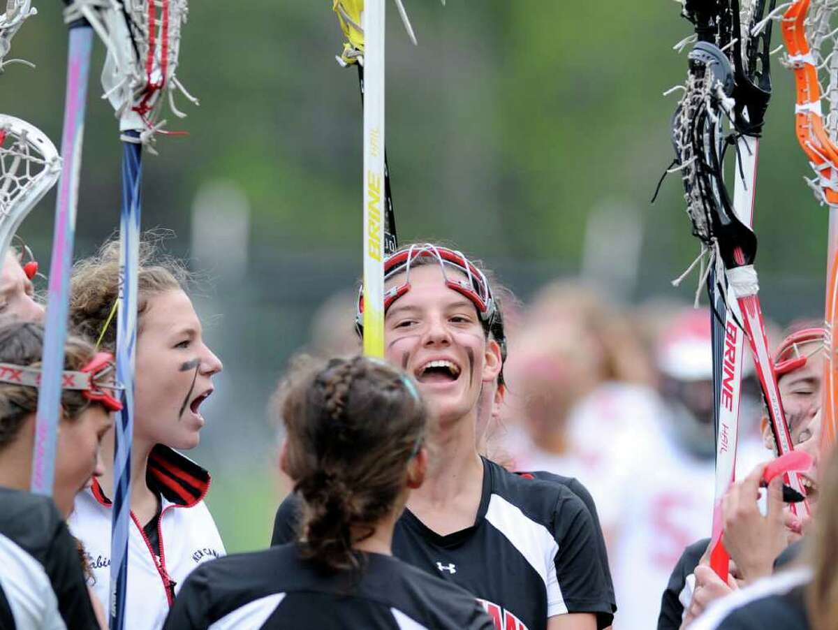 The New Canaan High School Rams celebrate their 14-9 victory over Greenwich during girls high school lacrosse game between Greenwich High School and New Canaan High School at Greenwich High School, Tuesday afternoon, May 3, 2011.
