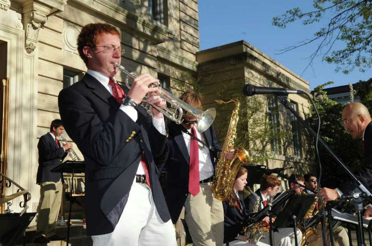 Warren Bein, a junior at Greenwich High School, plays a solo on his trumpet with the school's jazz ensemble at the opening night festivities of Art to the Avenue on Thursday, May 5, 2001.