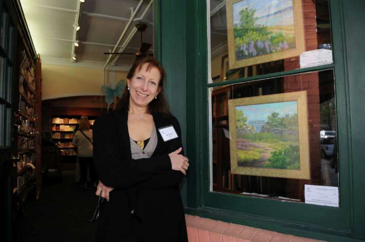 Artist Ilse Gordon, of Greenwich, stands with her paintings at Therese Saint Clair on Lewis Street during the opening night festivities of Art to the Avenue on Thursday, May 5, 2001.